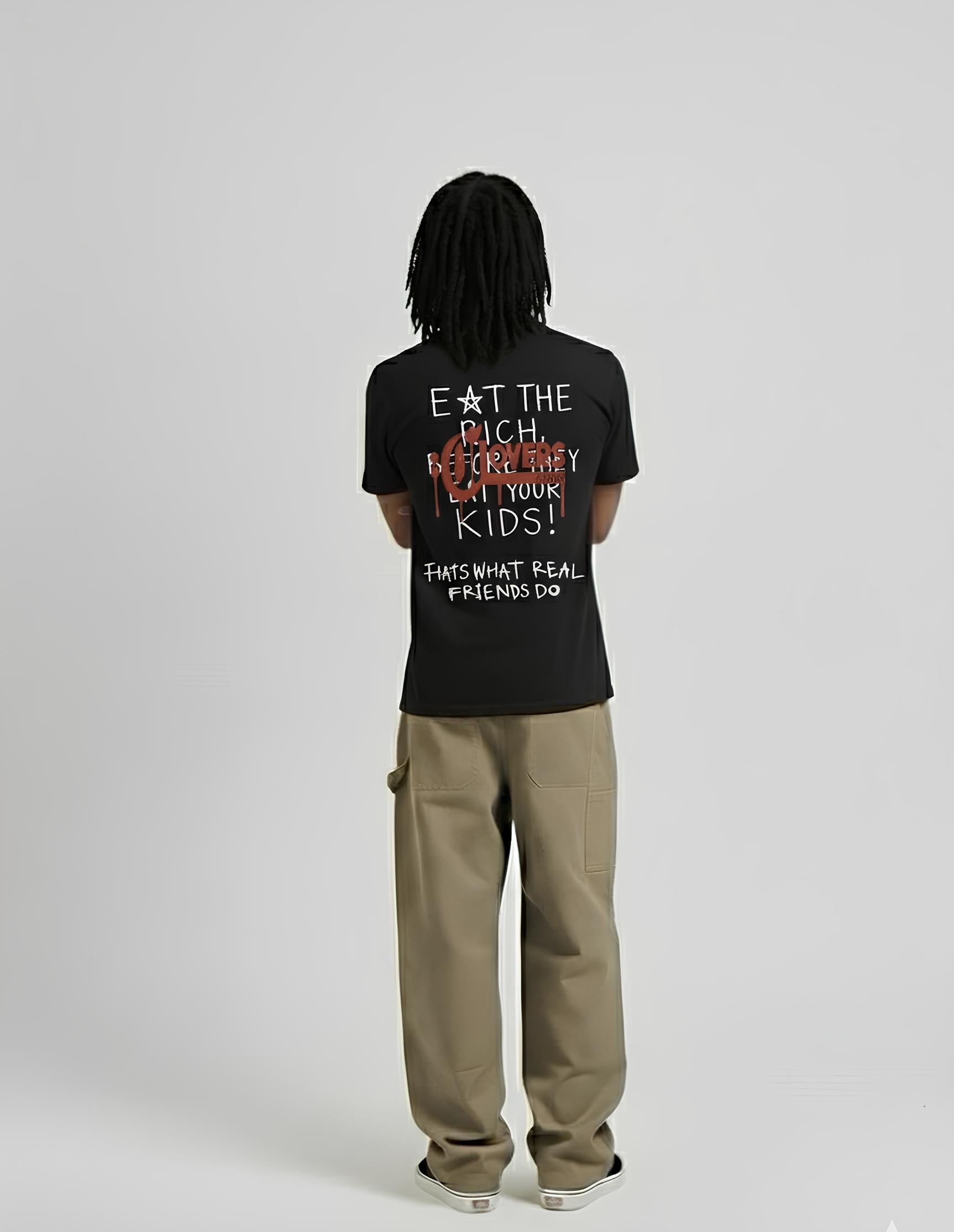 Person wearing a black t-shirt with text on the back, standing against a plain background