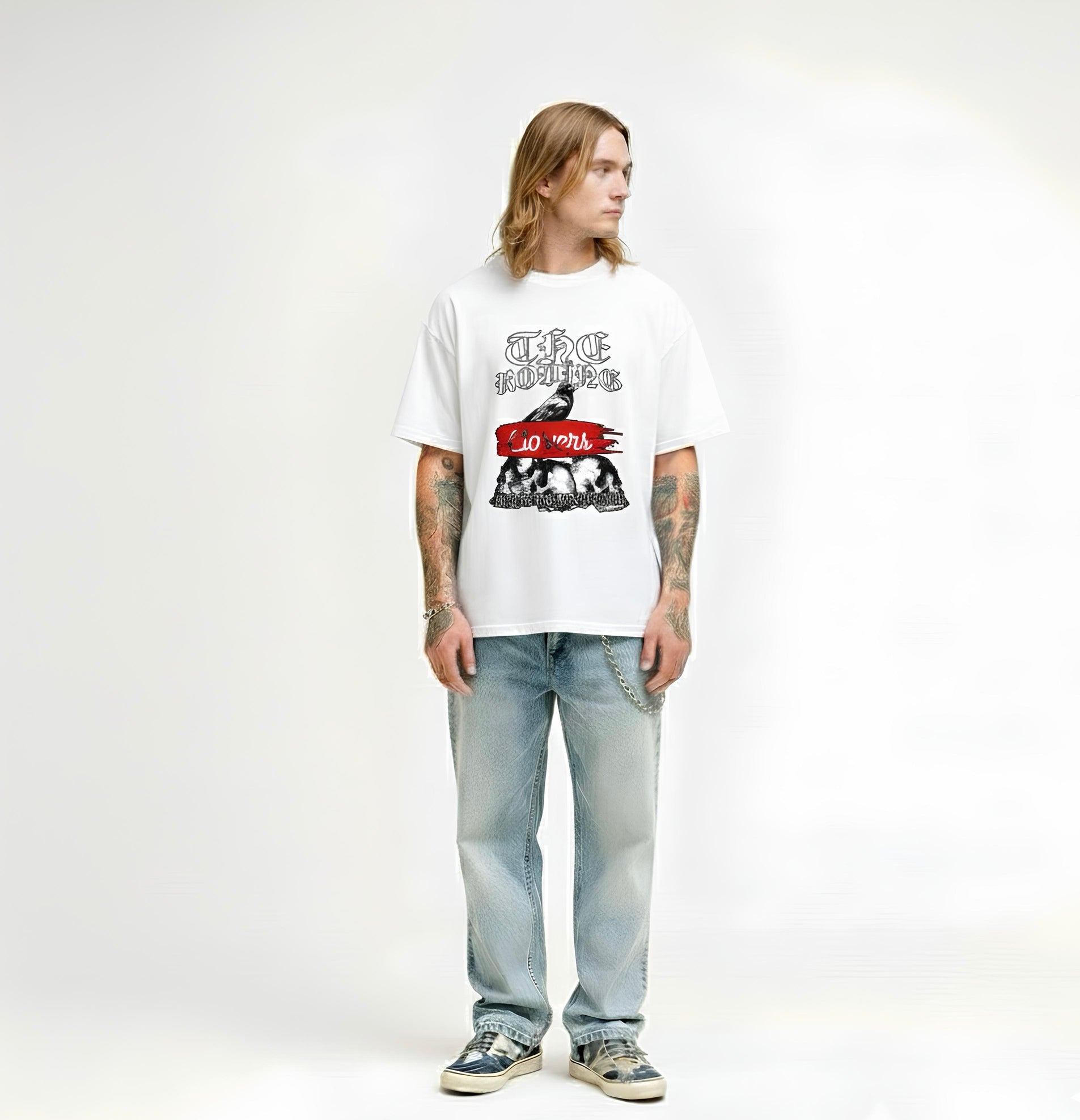 Person wearing a white t-shirt with graphic design and text, standing against a plain background