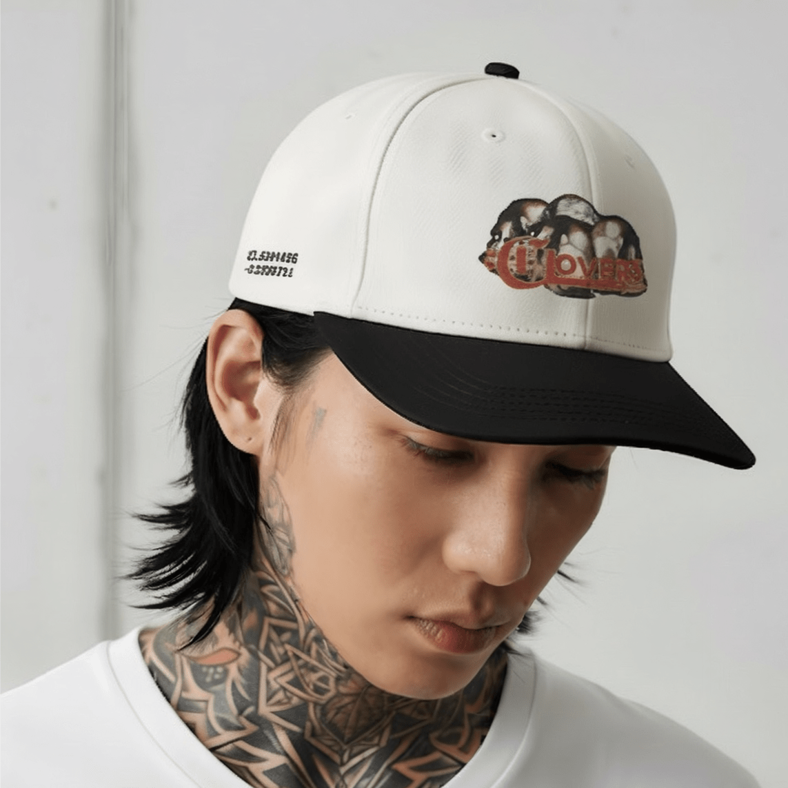 Person wearing a cap with a logo on a plain background