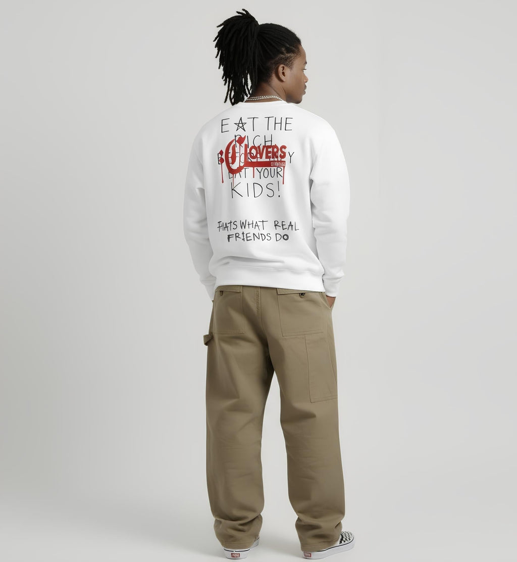Person wearing a white sweatshirt with text on the back, standing against a plain background