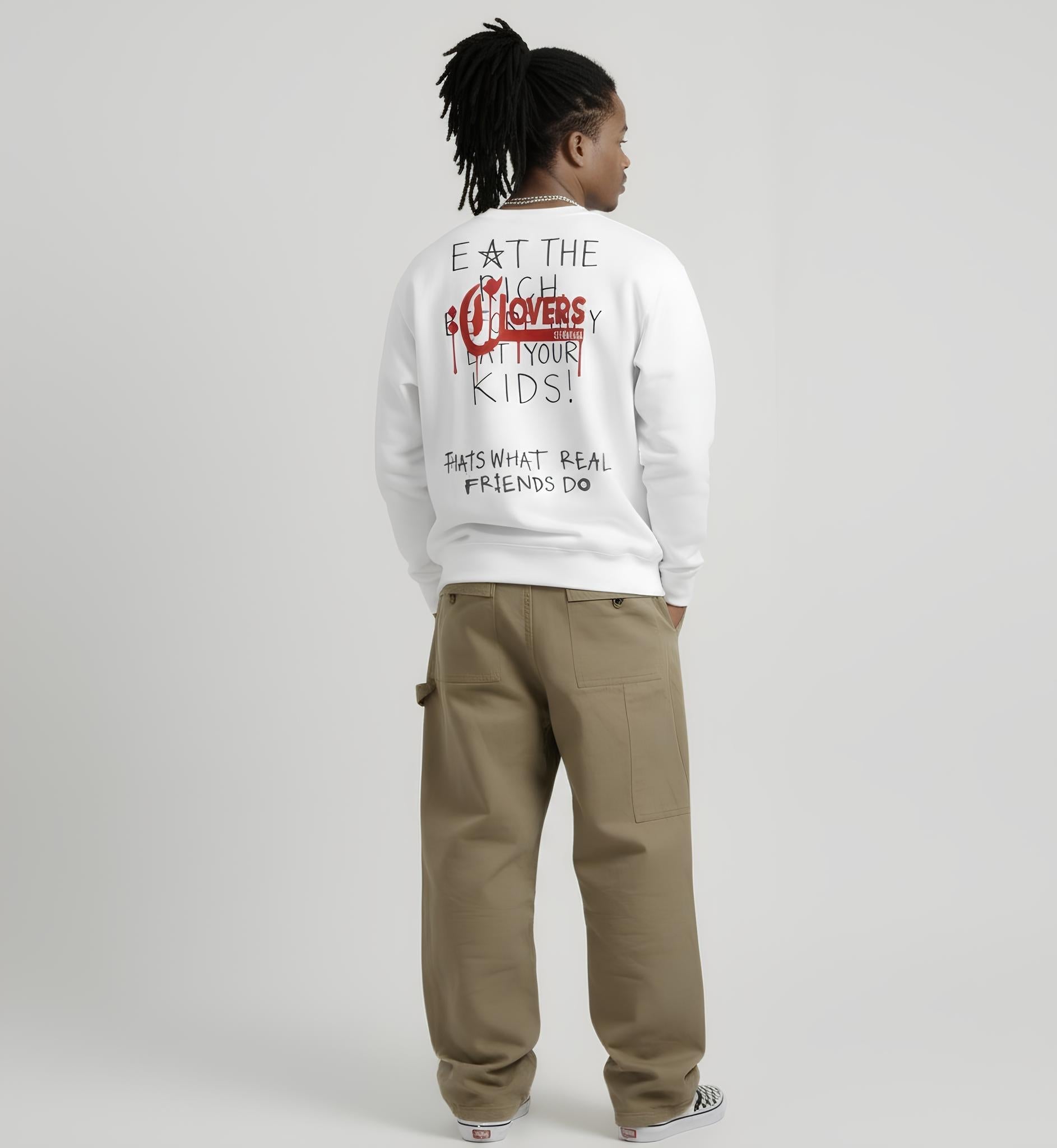 Person wearing a white sweatshirt with text on the back, standing against a plain background