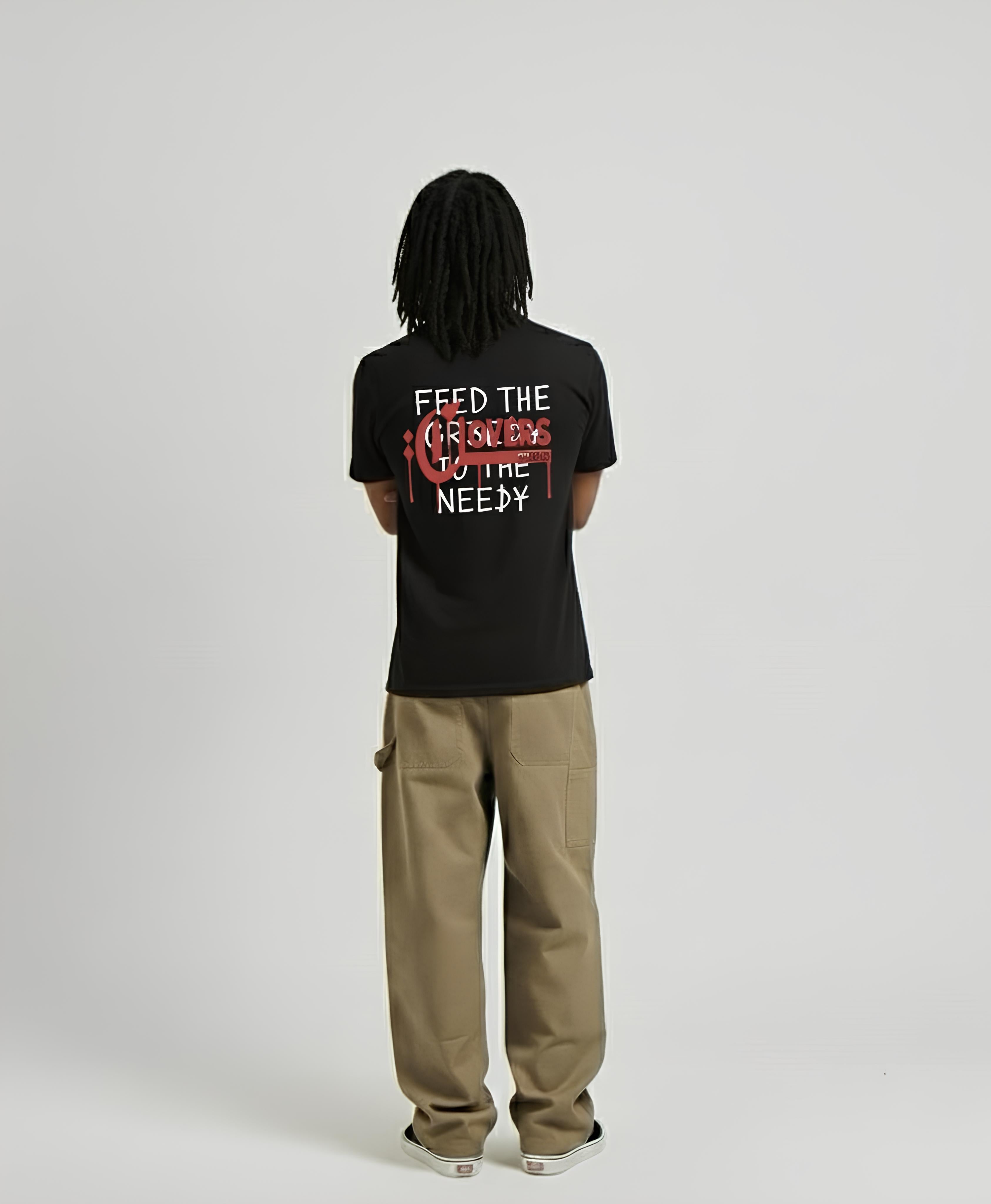 Person wearing a black t-shirt with text on the back, standing against a plain background