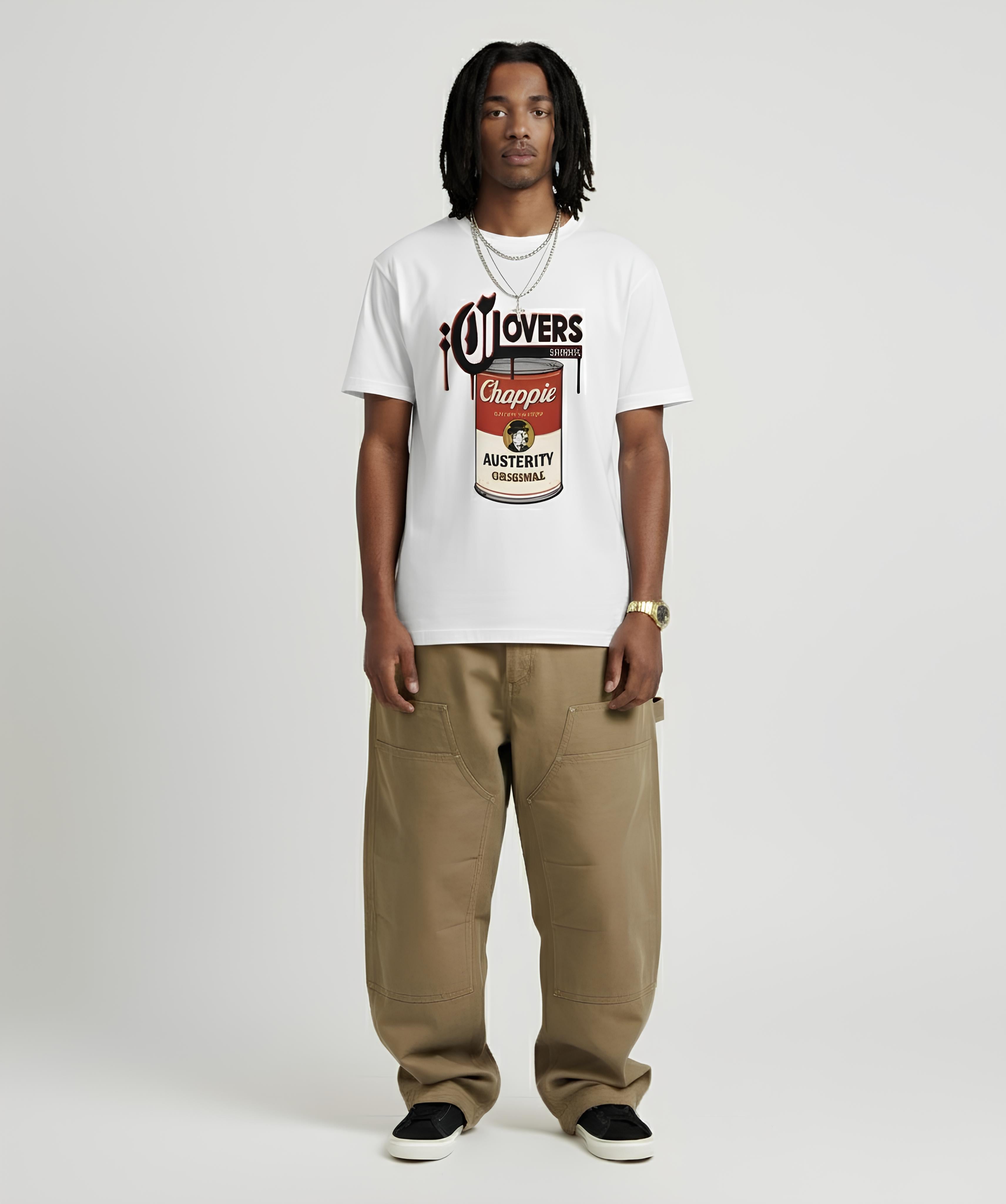 Person wearing a white t-shirt with a graphic design and brown pants on a white background