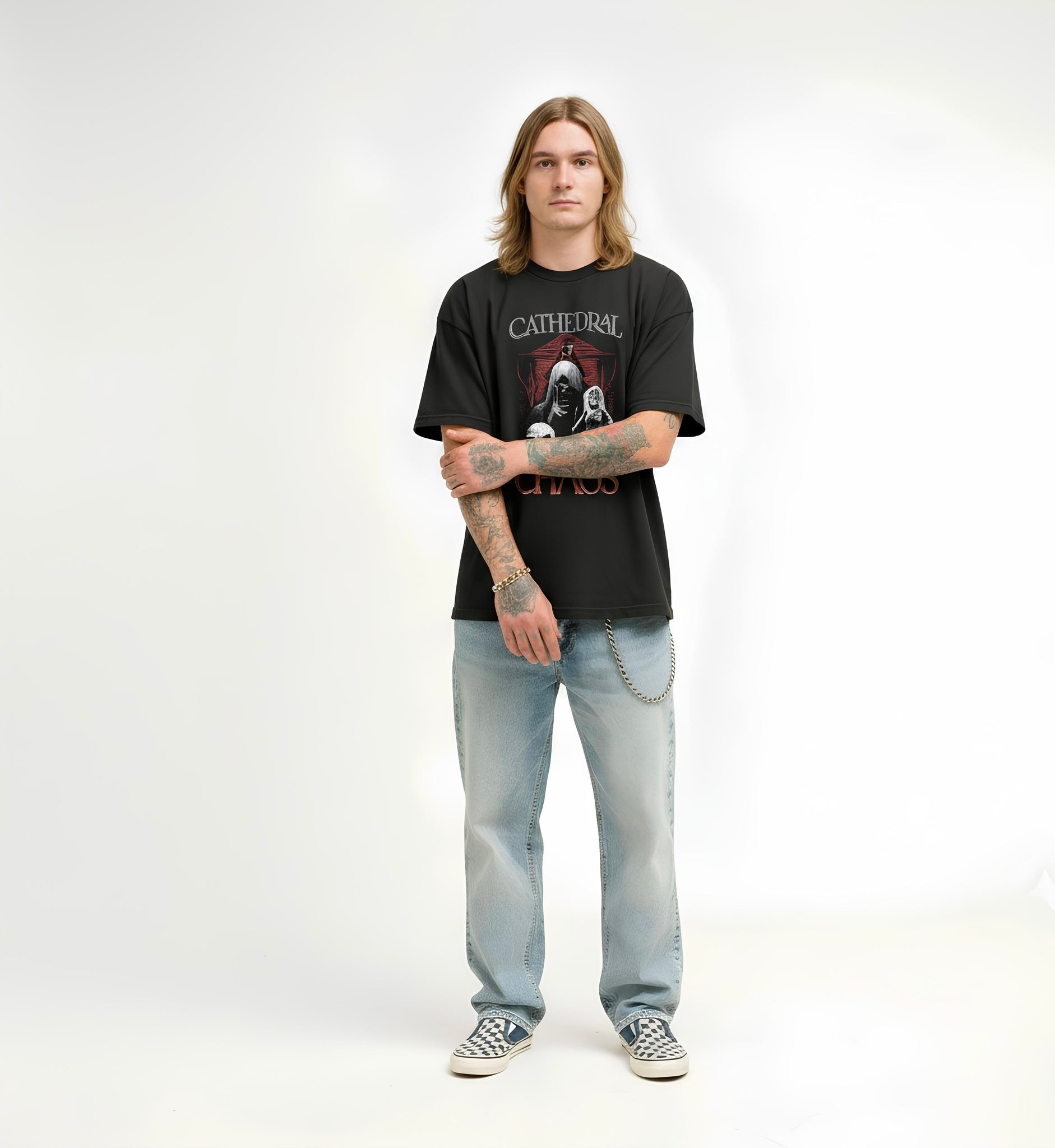 Person wearing a black t-shirt with a graphic design and light blue jeans on a white background